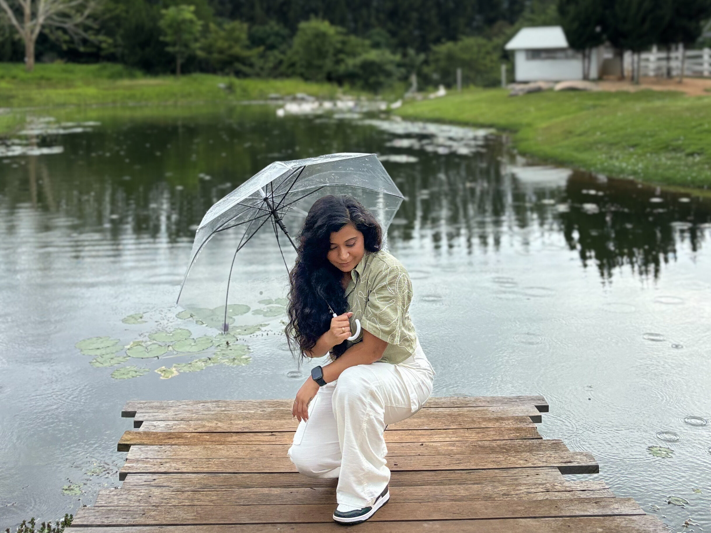 solo female traveller sitting by a pond in Khao Yai Thailand