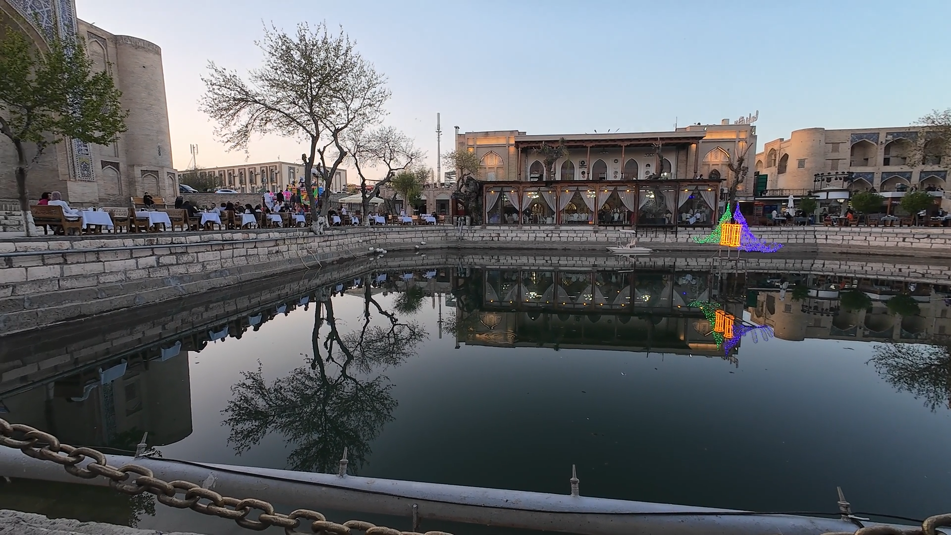 People gathering around Lyabi-Hauz on a quiet evening in Bukhara